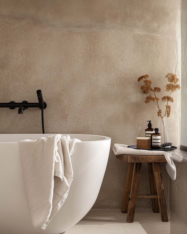 Salle de bains avec baignoire élégante et décoration minimaliste : Une salle de bains élégante avec une baignoire moderne et des touches décoratives en bois, offrant un espace épuré et relaxant.